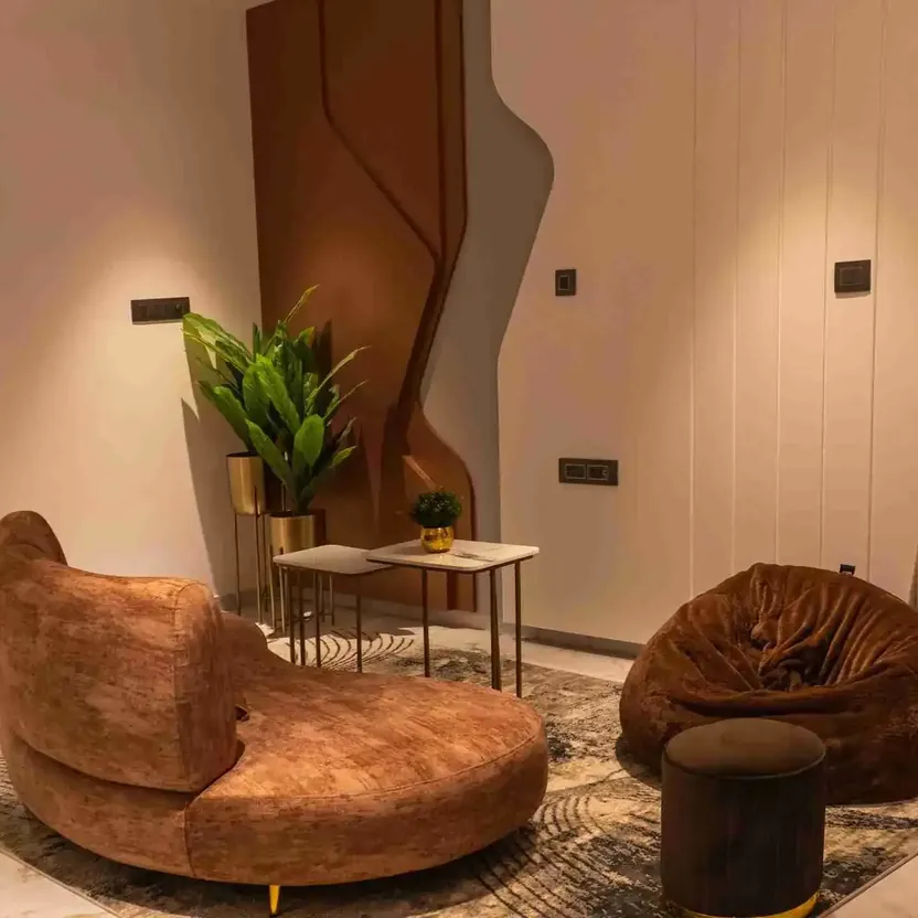 Elegance by Guru Punvaanii, Bidadi, show villa A lounge with a curved sofa, a bean bag and timber panelling in the Elegance show villa